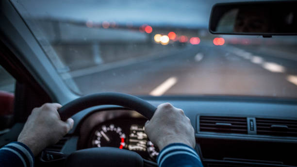 istock Mid adult man driving a car at night 1138950040