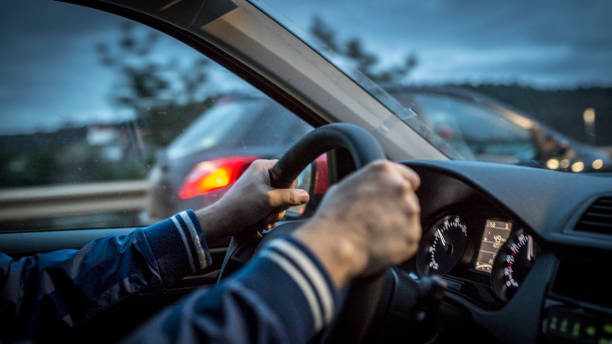 istock Mid adult man driving a car at night 1138950043