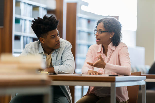 istock Volunteer tutor helps high school student 1138950147