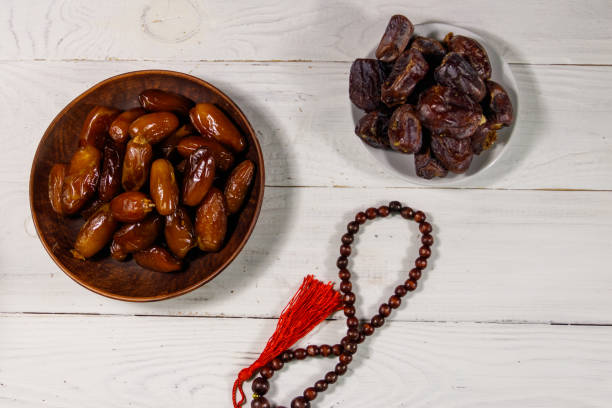 istock Dates fruit and prayer beads on white wooden table. Top view 1138950184