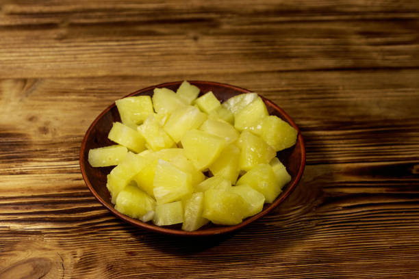 istock Canned pineapple pieces in ceramic plate on wooden table 1138950190
