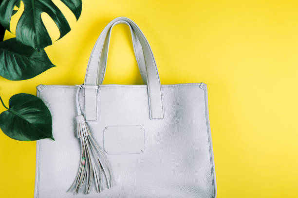istock Female hand bag and green leaf. 1138950654