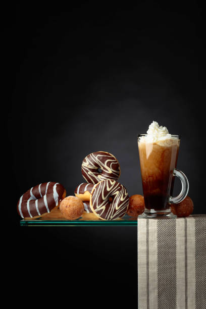 istock Chocolate donuts and coffee cocktail with cream. 1138950667
