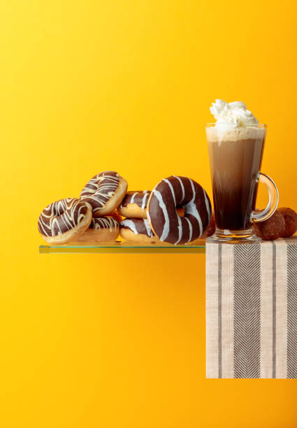 istock Chocolate donuts and coffee cocktail with cream. 1138950668