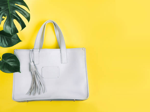 istock Female hand bag and green leaf. 1138950716