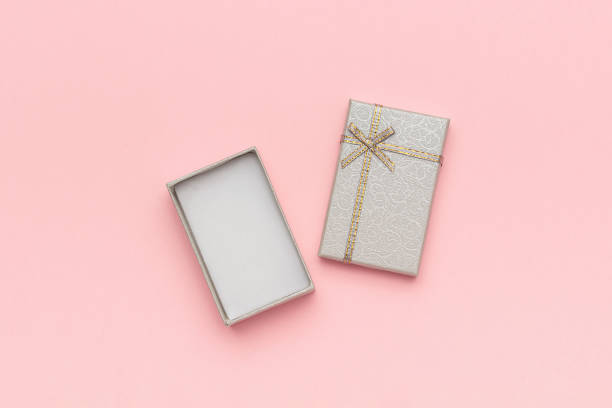 istock Open gray gift box with bow on pink pastel background in minimal style. Top view Copy space Mockup 1138955871