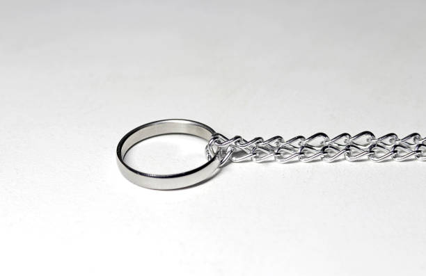 istock Silver ring tied in chain. On white background 1138957068