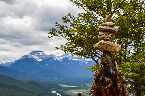 A native Inukshuk on a mountain in Banff overlooking the rockies.