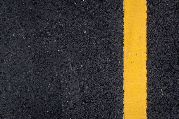 istock yellow line on the road texture background 1138960591