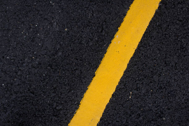 istock yellow line on the road texture background 1138960598