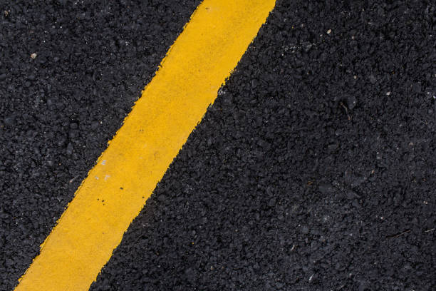 istock yellow line on the road texture background 1138960609
