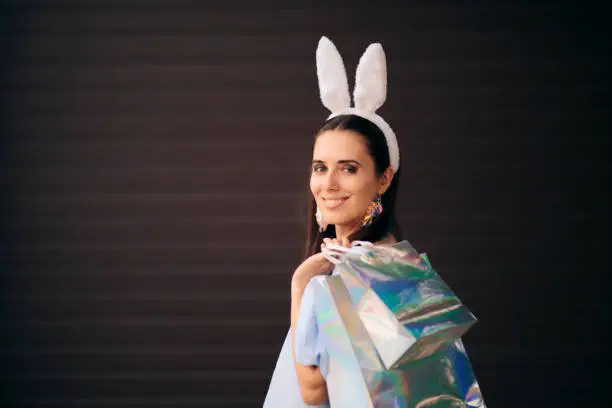 Photo of Woman with Easter Bunny Ears Holding Shopping Bags