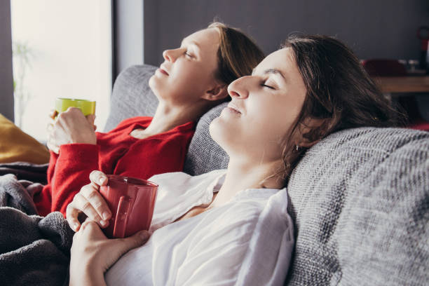 istock Female roommates having cold and resting at home 1138977738