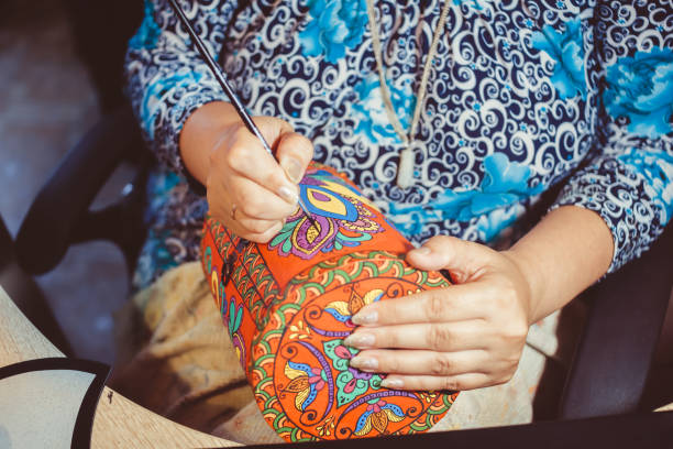 istock man draws with a brush on wood 1138978479