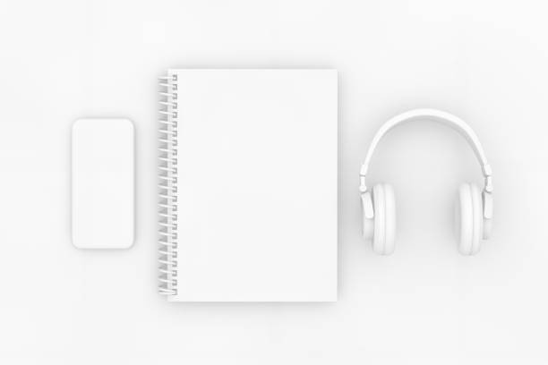 3d rendering of white color notebook with headphones and smartphone on white background. Office desktop, Workplace, Home Office.