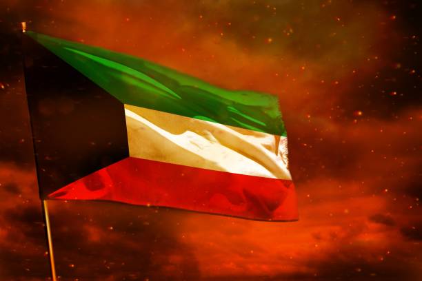 istock Fluttering Kuwait flag on crimson red sky with smoke pillars background. Troubles concept. 1138979784