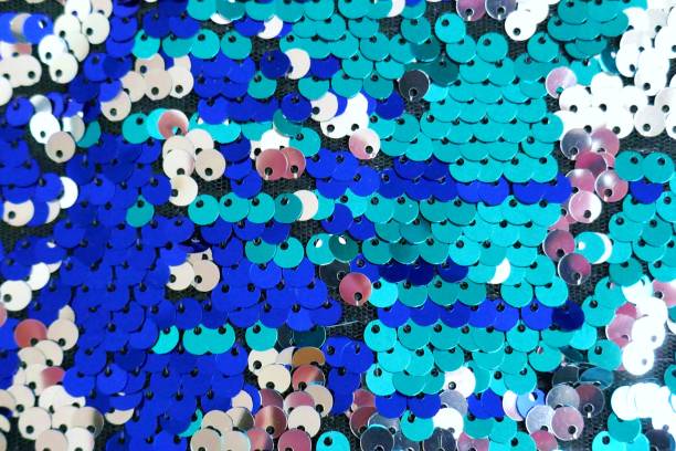 istock Sequins macro background.sequins in blue and turquoise tones.ridescent fabric.Scales background. fabric background. sequined textile 1138981151