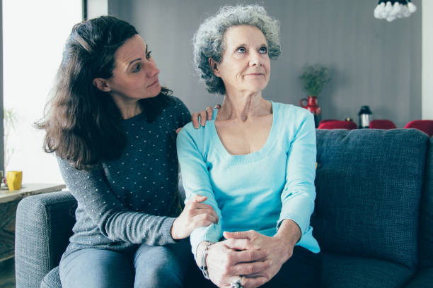 istock Woman holding hand on senior mother shoulder and supporting her 1138981945