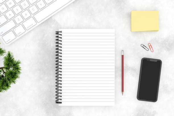 istock Top view of notebook with smart phone and keyboard on marble background 1138982096