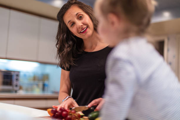 istock Mother with Daughter Active At Home Experiencing Quality Life in Kitchen Preparing Healthy Snacks 1138982288