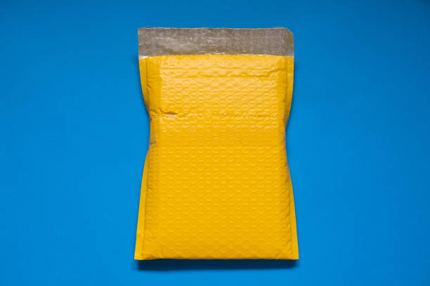 istock Yellow envelope made of bubble pack for prevent something from bumping or shockproof on blue background 1138982439
