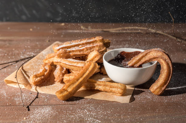 istock Churros with sugar and chocolate sauce 1138984228