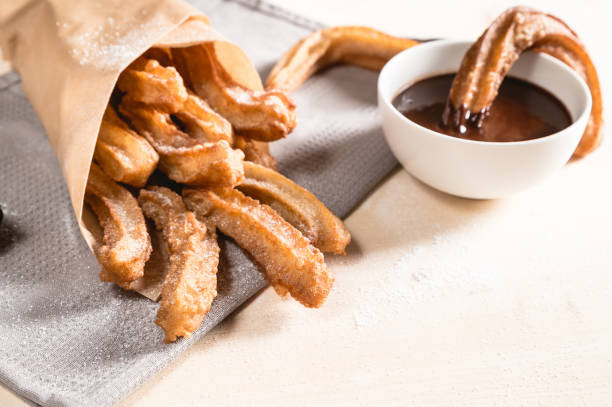 istock Churros with sugar and chocolate sauce 1138984229