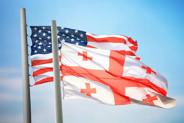 Flags of Georgia and the USA Flags of Georgia and the USA against the background of the blue sky georgia flag country stock pictures, royalty-free photos & images