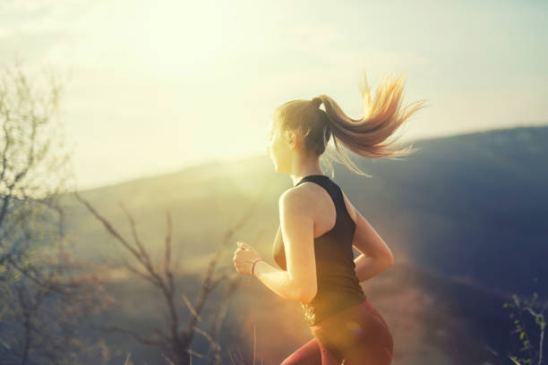 istock Young female running on sunset in nature. 1138992395
