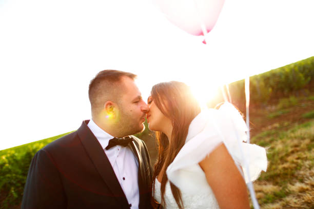 istock Beautiful wedding couple posing with balloons in nature 1138992576