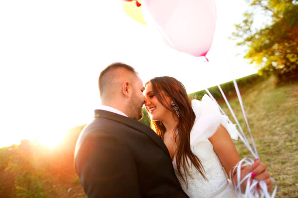 istock Beautiful wedding couple posing with balloons in nature 1138992584