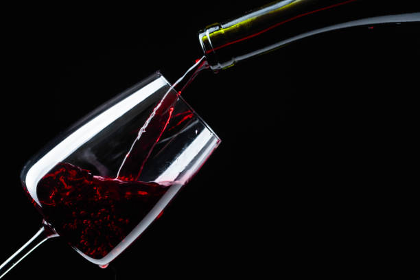 istock Red wine being poured into wineglass. 1138997415