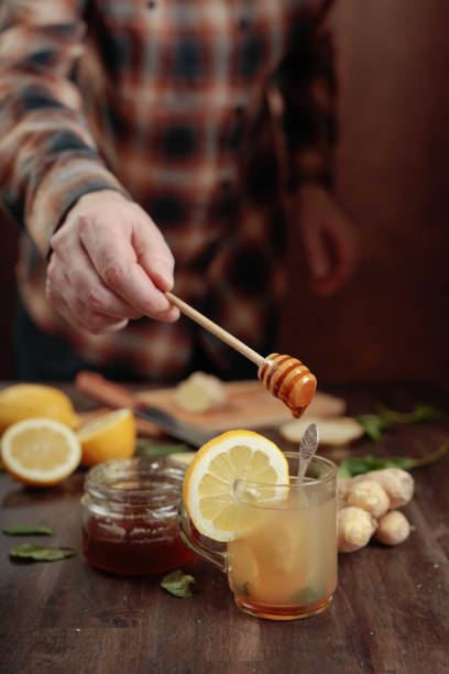 istock Ginger tea with honey , lemon and mint on old wooden table . 1138997433