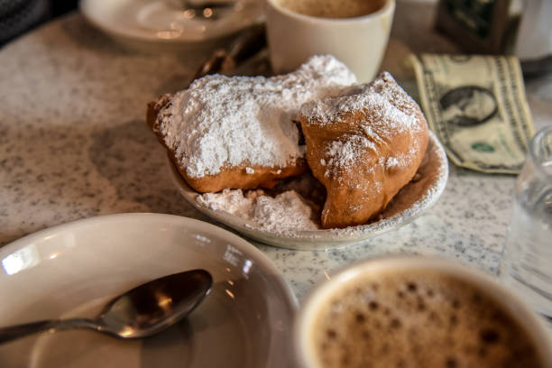 Breakfast in New Orleans (USA) Beignet is one of the classic breakfast pastries of New Orelans beignet stock pictures, royalty-free photos & images