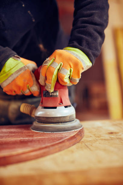 istock Male carpenter using orbital electric sander in a retro vintage workshop. 1139001648