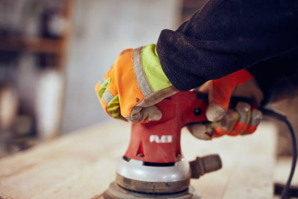 istock Male carpenter using orbital electric sander in a retro vintage workshop. 1139003343