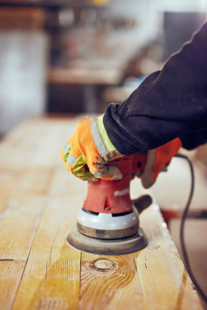 istock Male carpenter using orbital electric sander in a retro vintage workshop. 1139004385