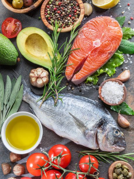 istock Raw dorado fish and salmon steak with spices and vegetables. 1139006210