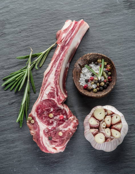 istock Raw lamb chops with garlic and herbs. 1139008022