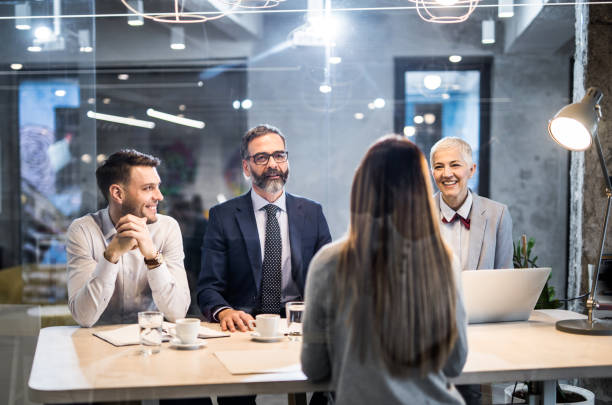 istock Human resource team talking to female candidate in the office. 1139011182