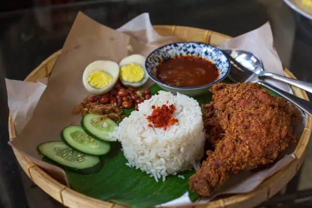 Photo of Nasi lemak is a Malay fragrant rice dish cooked in coconut milk and pandan leaf. it is the most popular street food in malaysia