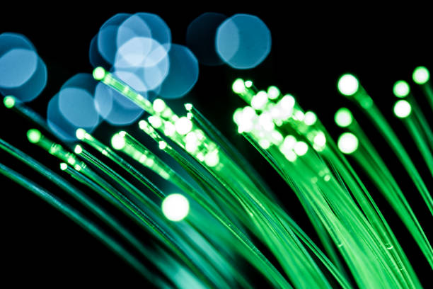 istock Bundle of optical fibers with green light. 1139013383