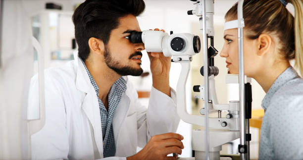 istock Attentive optometrist examining female patient on slit lamp 1139014115