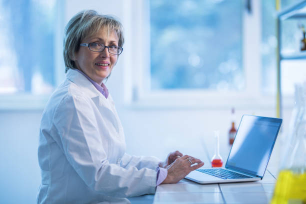 istock Happy mature forensic scientist working on laptop in a laboratory. 1139015522