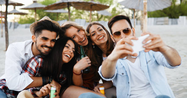 istock Group of young friends laughing and drinking beer 1139017503