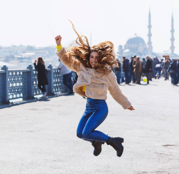 istock Happy jumping girl on the bridge 1139020556