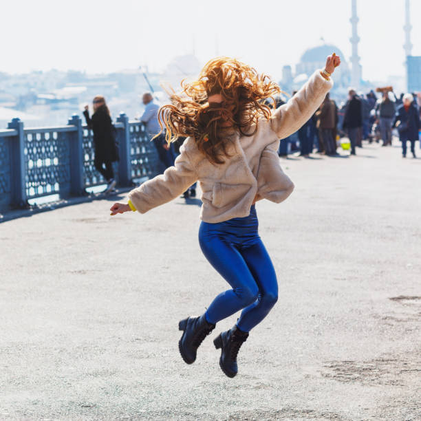 istock Happy jumping girl on the bridge 1139020558