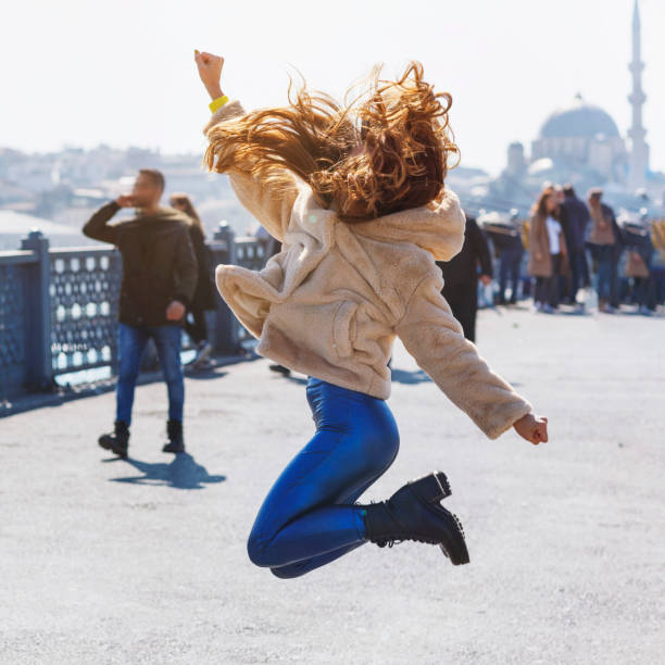 istock Happy jumping girl on the bridge 1139020567