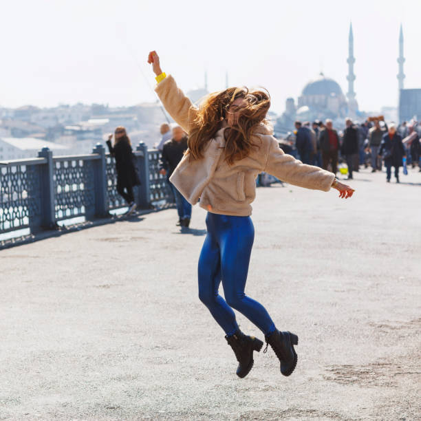 istock Happy jumping girl on the bridge 1139020711