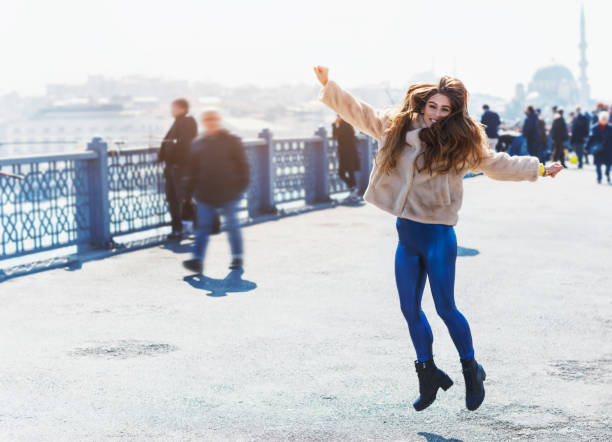 istock Happy jumping girl on the bridge 1139020752